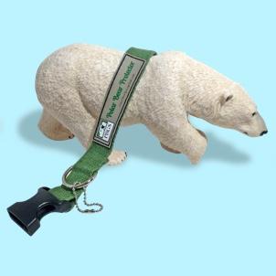 Polar Bear Protector green hemp collar draped over back of tabletop polar bear